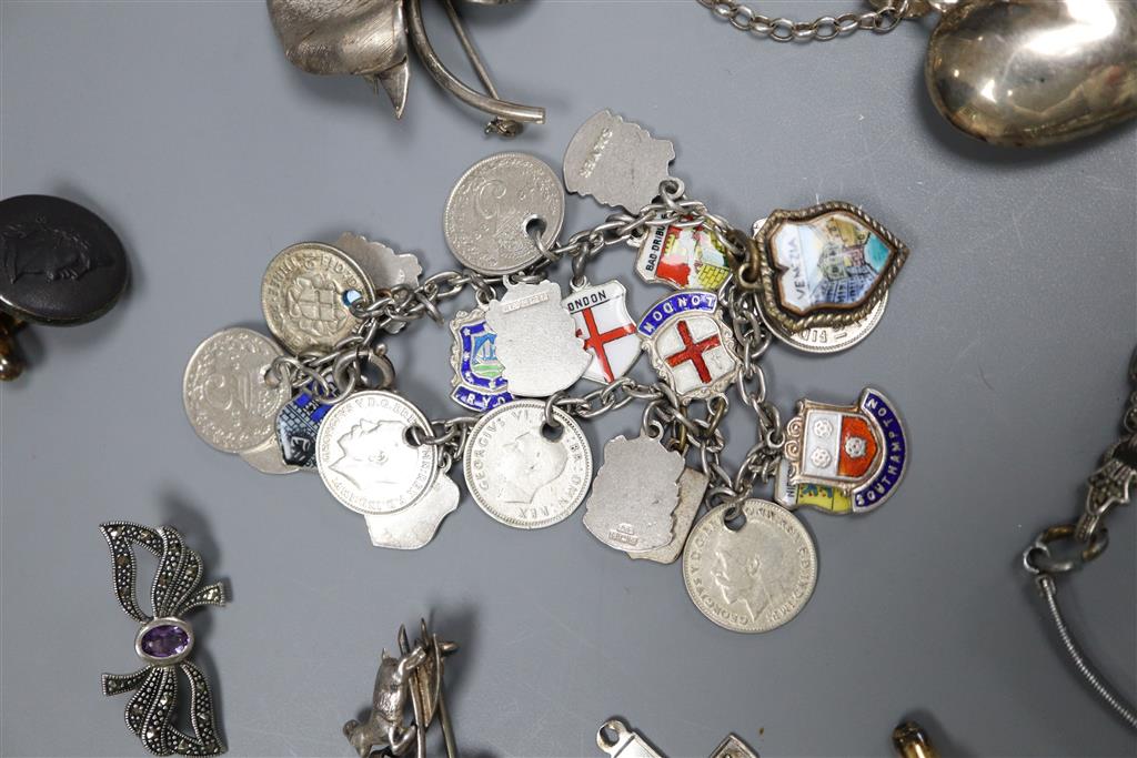 A white metal charm bracelet hung with enamel medallions, one other charm bracelet, marcasite watch and pendant etc.